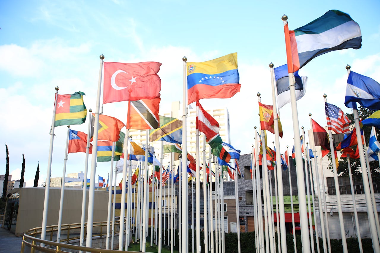 Home A vibrant collection of international flags in a cityscape setting, symbolizing global unity.