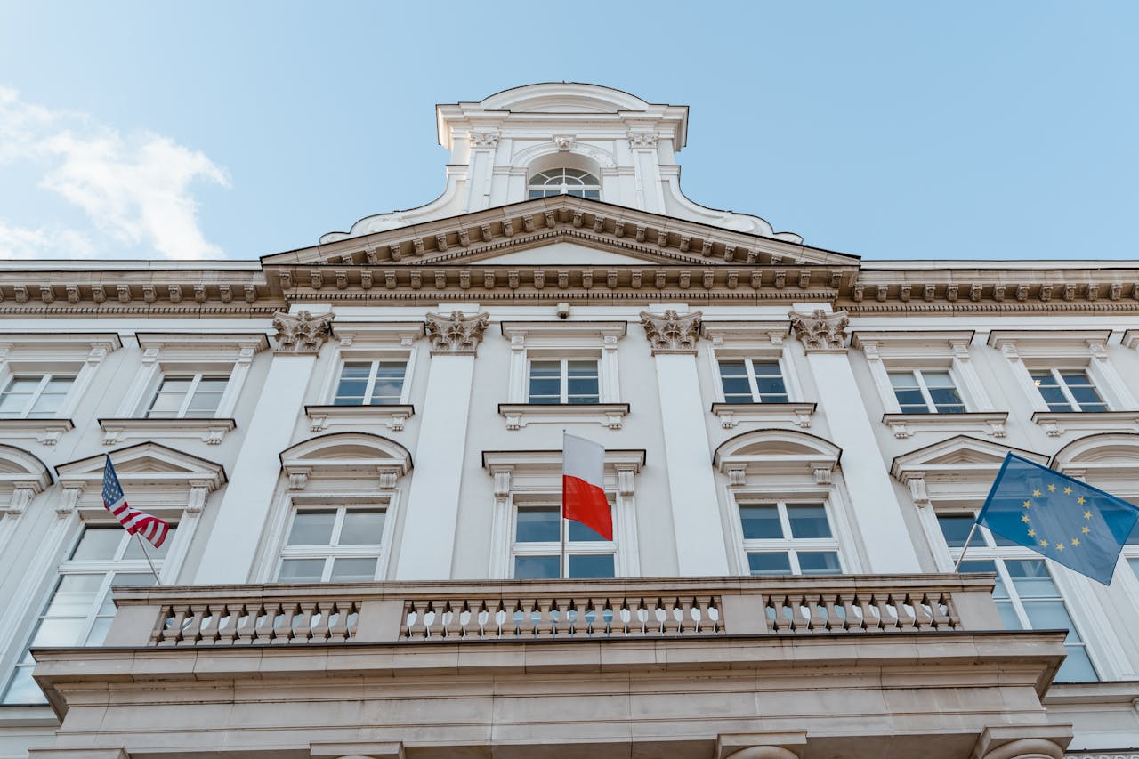 A classic architectural facade with multiple flags, showcasing international representation.